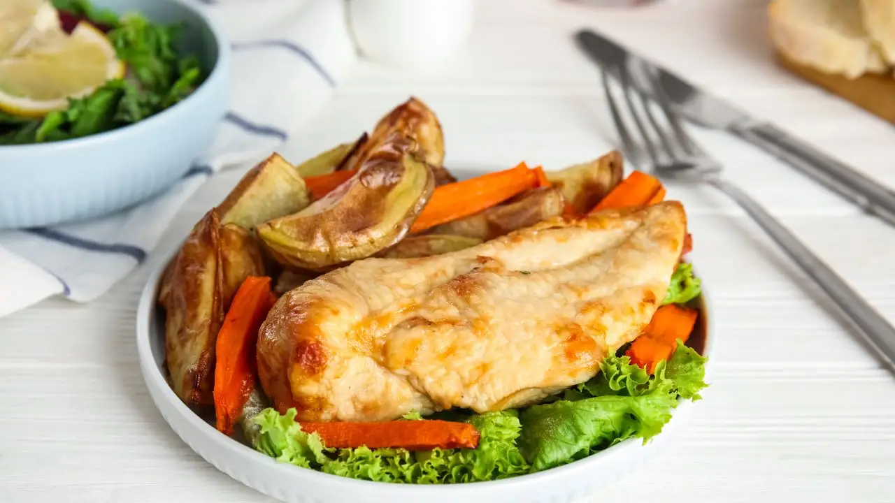 Healthy coconut curry chicken served with roasted potatoes and carrots on a bed of lettuce, showcasing nutritious meal options from Culinary Collective ATL.