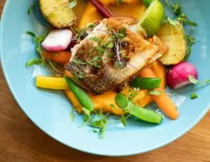 Fish on a bed of sweet potato mashed with vegetables